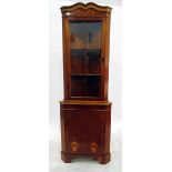 Reproduction walnut corner cabinet with glazed upper section enclosing two shelves,