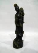 Carved jade figure of a diety holding lotus flower, on plinth base,