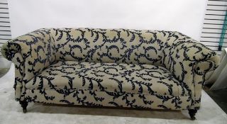 Victorian Chesterfield settee of typical form and upholstered in blue and beige weave with foliate