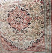 Silk prayer rug showing animals, with a central cartouche, all on a pale rust-coloured ground,