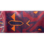 Old Baluchi wool rug with four stylised orange tulips to the red field and having stiff leaf