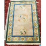 Washed Chinese style rug depicting exotic birds and with a floral border, fringed, 195cm x 123cm