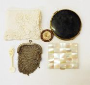 Mother-of-pearl lidded compact, another compact, a small mesh purse,  a small bone spoon and a