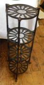 Robert Welch cast iron pot stand, circa 1987, four-tiered with spiral twist supports, on shaped