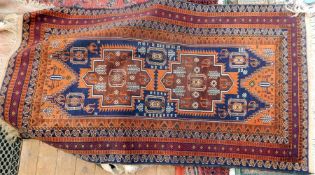 Persian style wool rug, orange decorations on a maroon ground, 135cm x 89cm