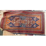 Persian style wool rug, orange decorations on a maroon ground, 135cm x 89cm