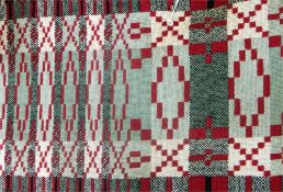 Large Welsh woollen blanket in shades of green and red, with fringe