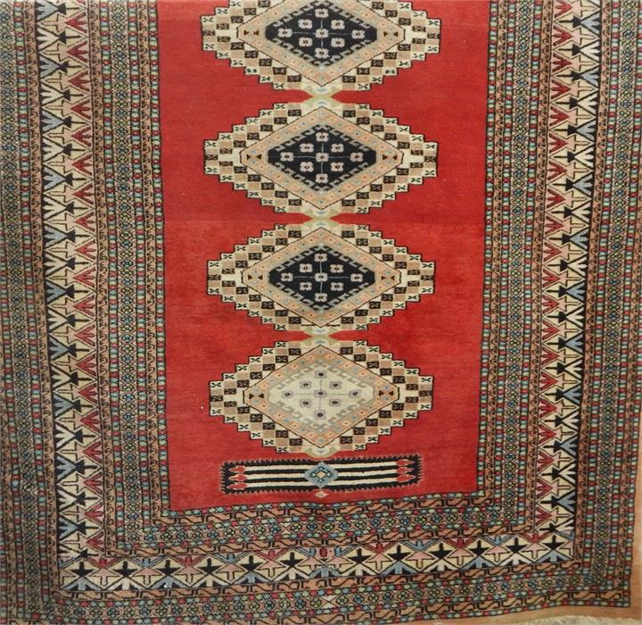 Eastern style rug, red ground with lozenge design