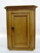 19th century pine hanging corner cupboard enclosed by panelled door, 88cm wide and an old pine stool