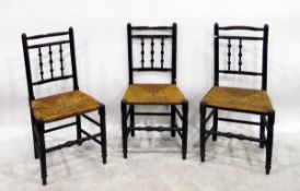 Set of four stained wood country spindle back rush-seated chairs on turned supports and cross