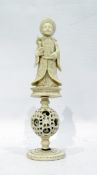 Carved Chinese ivory puzzle ball figure of mandarin holding scepter, above puzzle ball, height 17.