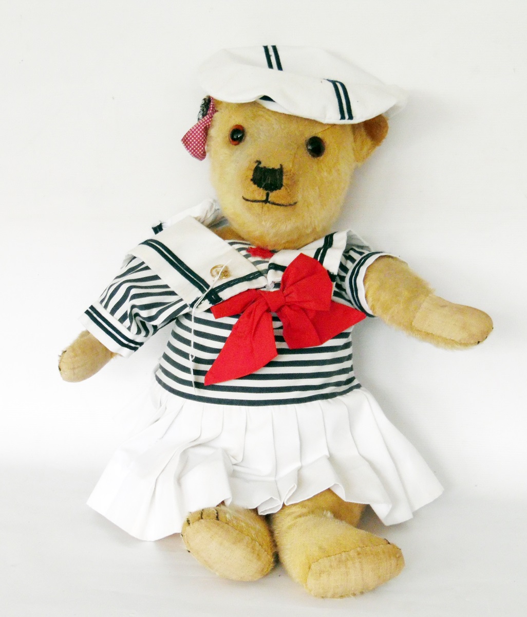 Early/mid 20th century plush bodied bear with glass eyes, sewn nose and mouth, movable limbs, 63cm