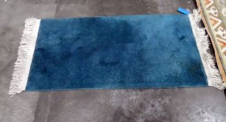 Chinese washed wool rug, teal blue with cut floral and foliate decoration, 182cm x 79cm approx