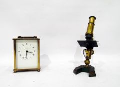 Brass and painted metal small microscope and a Henley quartz carriage clock (2)