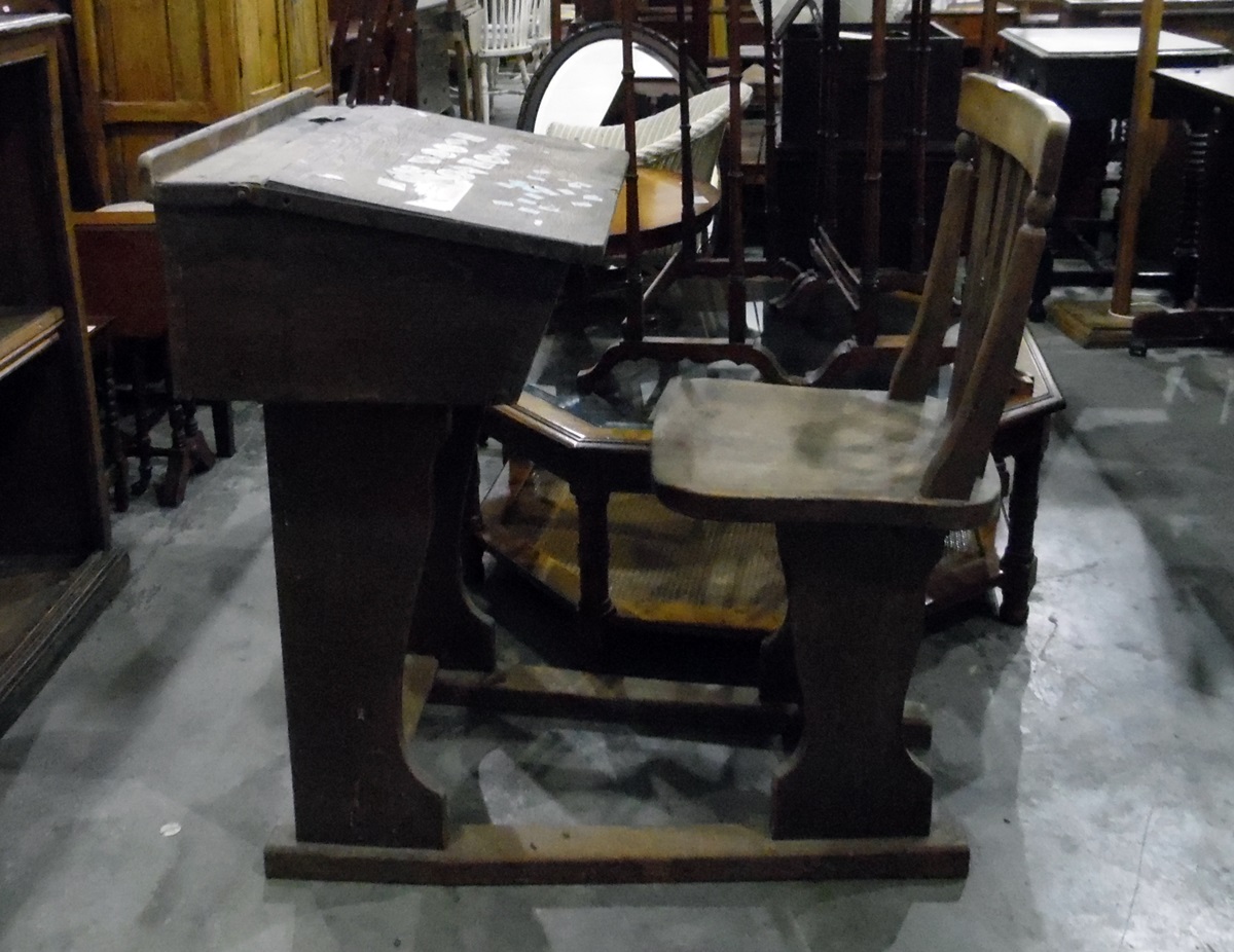 Early 20th century oak school desk and slat back chair united on a platform base