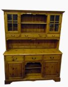 Modern pine dresser, the upper section having two cupboards enclosed by glass panelled doors, open