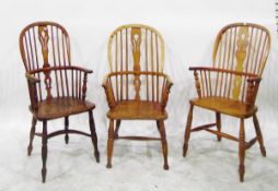 Set of four matched elm seated and ash spindle back elbow chairs with fret carved splat, turned