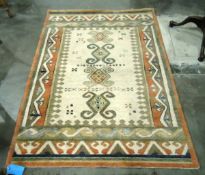 Modern wool rug in stylised Eastern design, the cream ground with four hooked lozenge medallions,