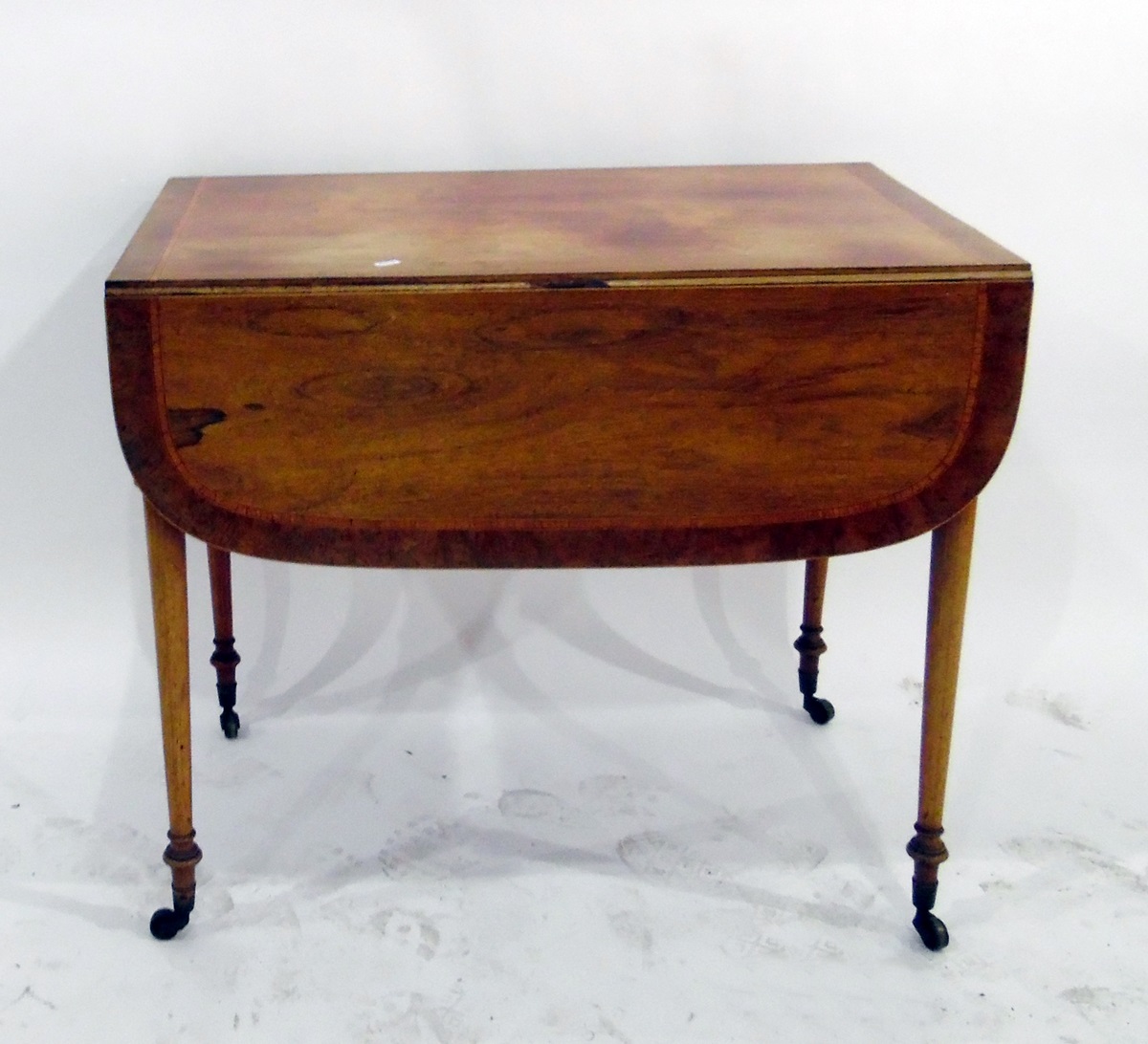 Faded rosewood yew veneered and satinwood banded Pembroke table on turned supports, fitted drawer to