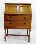 Mid 20th century oak bureau, the panelled fall revealing pigeonhole interior over two long drawers