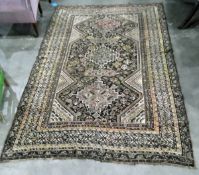 Persian style wool rug, the brown field with three stepped lozenge medallions, surrounded by bird