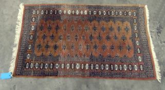 Persian style wool rug, the mushroom ground with stylised foliate and hooked rectangular motifs to