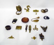 Assortment of brass door knockers and handles, brass rings, curtain hooks, etc