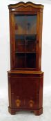 Reproduction yew corner cabinet with glazed upper section enclosing two shelves, with cupboard