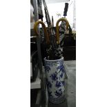 Ceramic Chinese-style umbrella stand with two vintage umbrellas, a golf umbrella, a parasol, a