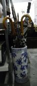 Ceramic Chinese-style umbrella stand with two vintage umbrellas, a golf umbrella, a parasol, a