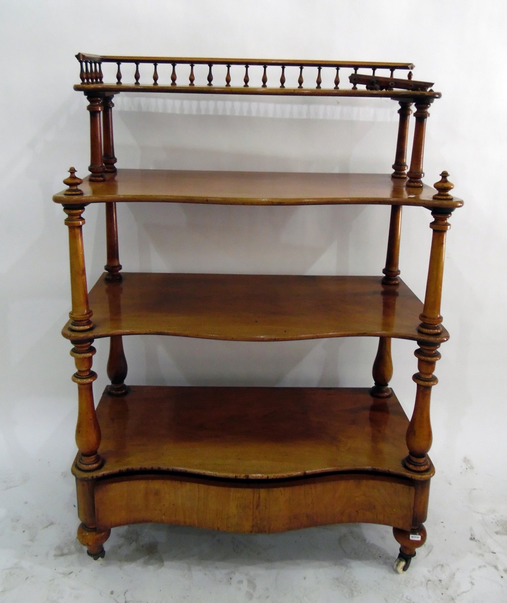 Victorian four-tier buffet of serpentine outline, having turned spindle gallery to superstructure,