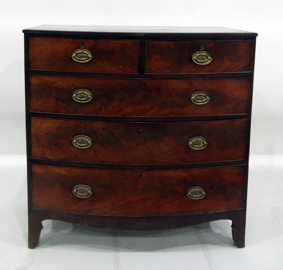 Early 19th century mahogany cross-banded bowfront chest of two short and three long graduated