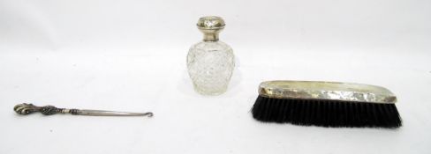 Silver-topped cut glass scent bottle, floral swag decoration (marks worn), a silver-handled button