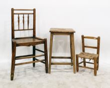 Elm and oak stool, a child's beech framed rush seated chair and an elm and beech chair with turned