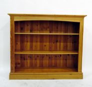 Pine bookcase display unit having flat moulded cornice, fluted pilasters, open shelves and on plinth