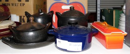 Two cast iron casseroles, three stoneware casseroles and two dishes