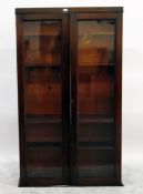 Mahogany bookcase enclosed by two glass panelled doors, 100cm wide