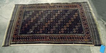 Persian style wool rug, the red ground with rows of hooked lozenge medallions, stylised floral