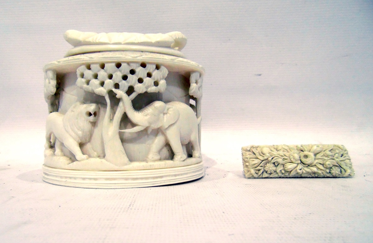 Early 20th century ivory lidded box with carved relief of animals, including elephant, lion, camel