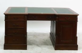 Reproduction mahogany kneehole pedestal desk, the writing surface having three leather inset