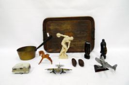 Two metal model aeroplanes, two African carved hardwood busts, brass and iron saucepan, wooden