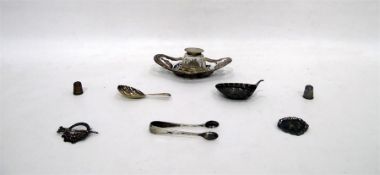 Silver capped glass inkwell within a foliate silve