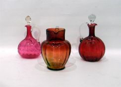 Two cranberry glass wine decanters with stoppers a