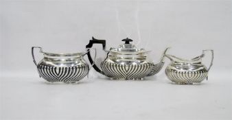 Three-piece silver tea set of half reeded pattern,