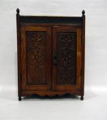 Edwardian oak wall cabinet enclosed by two carved