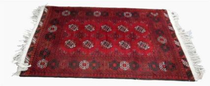 Afghan style wool rug, red ground with black and white decoration, 112 cm x 175 cm