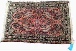 A modern Persian style wool rug, pink ground with brown floral decoration, 126 cm x 81 cm