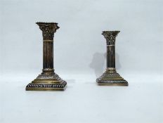 Pair of Corinthian column silver candlesticks on s