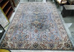 A Persian style wool rug, blue ground with orange and beige floral decoration, labelled to