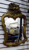 Shield-shaped mirror within a giltwood surround, h